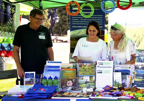 Rural Development State Director Vicki Walker staffing the USDA booth at the Eugene/Springfield Pride Festival