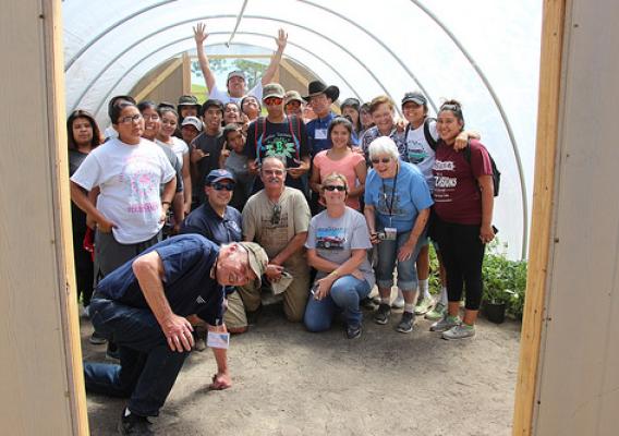 NACR&DC members posing with Reno-Sparks Indian Colony teens in hoop house