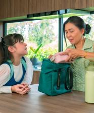 A woman with a child packing lunch